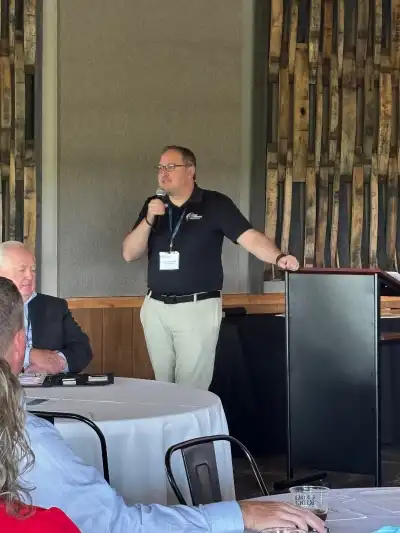 image of a man speaking to a group of people